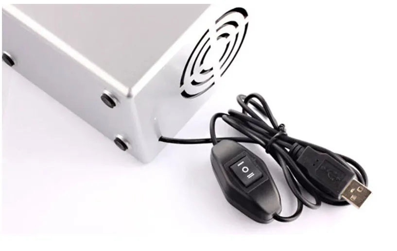 Silver USB mini fridge with open door showing two beverage cans and interior LED light