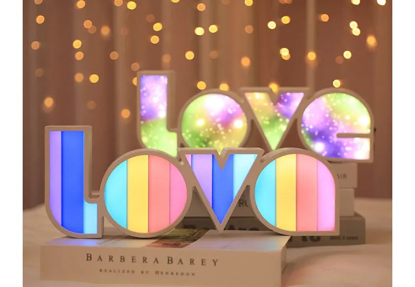Rainbow style LED LOVE decorative table lamp with plastic shade on a table