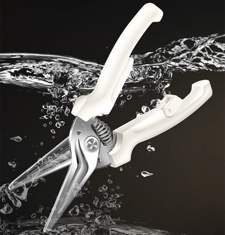 Creative magnetic suction kitchen scissors in stainless steel on a fridge door