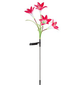 Solar lily flower light with silk cloth head, colour-changing LEDs, and stainless steel stake in a garden setting