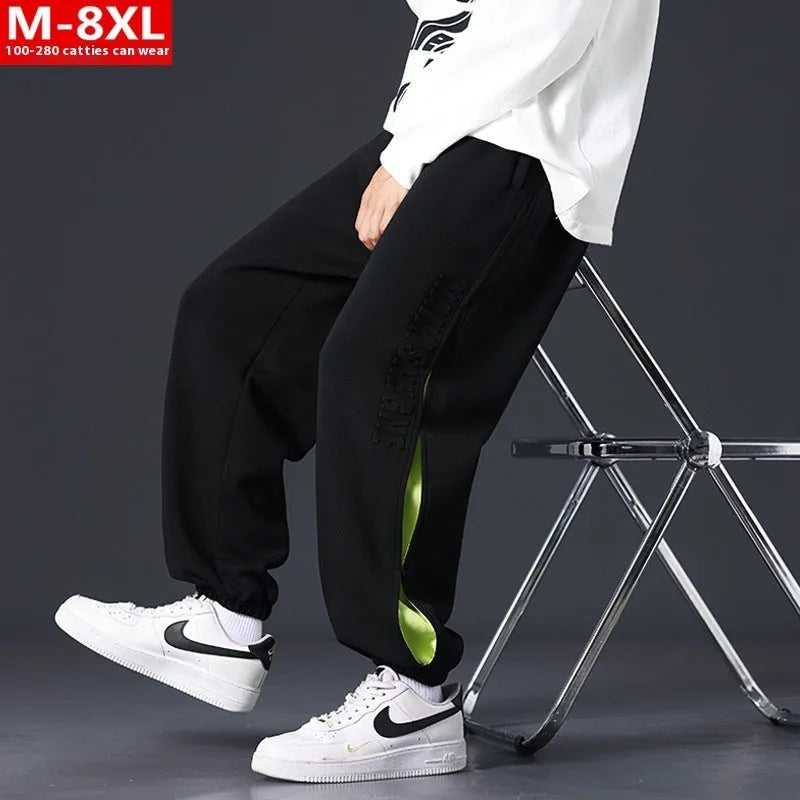 Men's loose fit cotton pants with elasticated ankle bands in grey green colour, showing collage stitching detail.