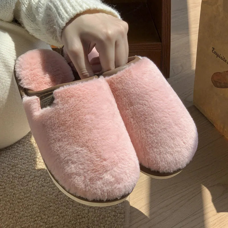 Solid colour winter plush slippers with non-slip PVC soles on a wooden floor