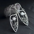 Silver women's earrings with lotus vine design featuring geometric floral patterns and circular rhinestones