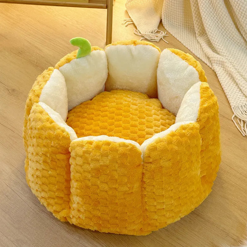 Orange pumpkin-shaped pet nest bed for cat or small dog with cotton filling.