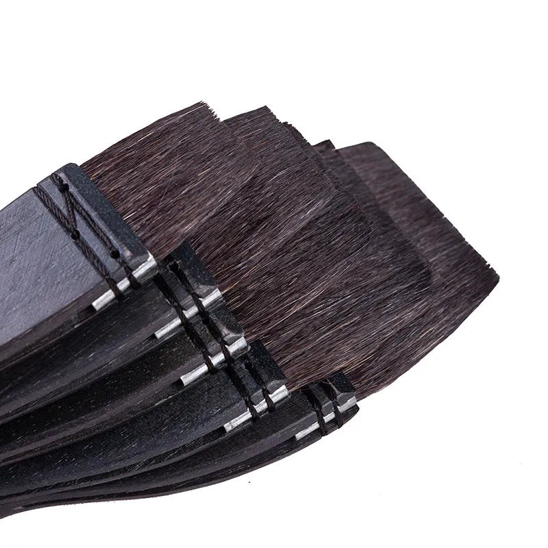 Grey squirrel hair artist paint brush with a light wood handle on a white background