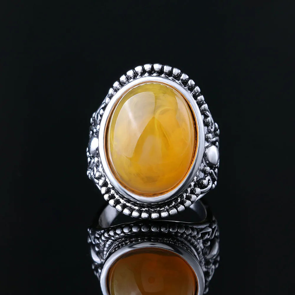 Geometric retro alloy ring in antique silver amber colour on a grey background.