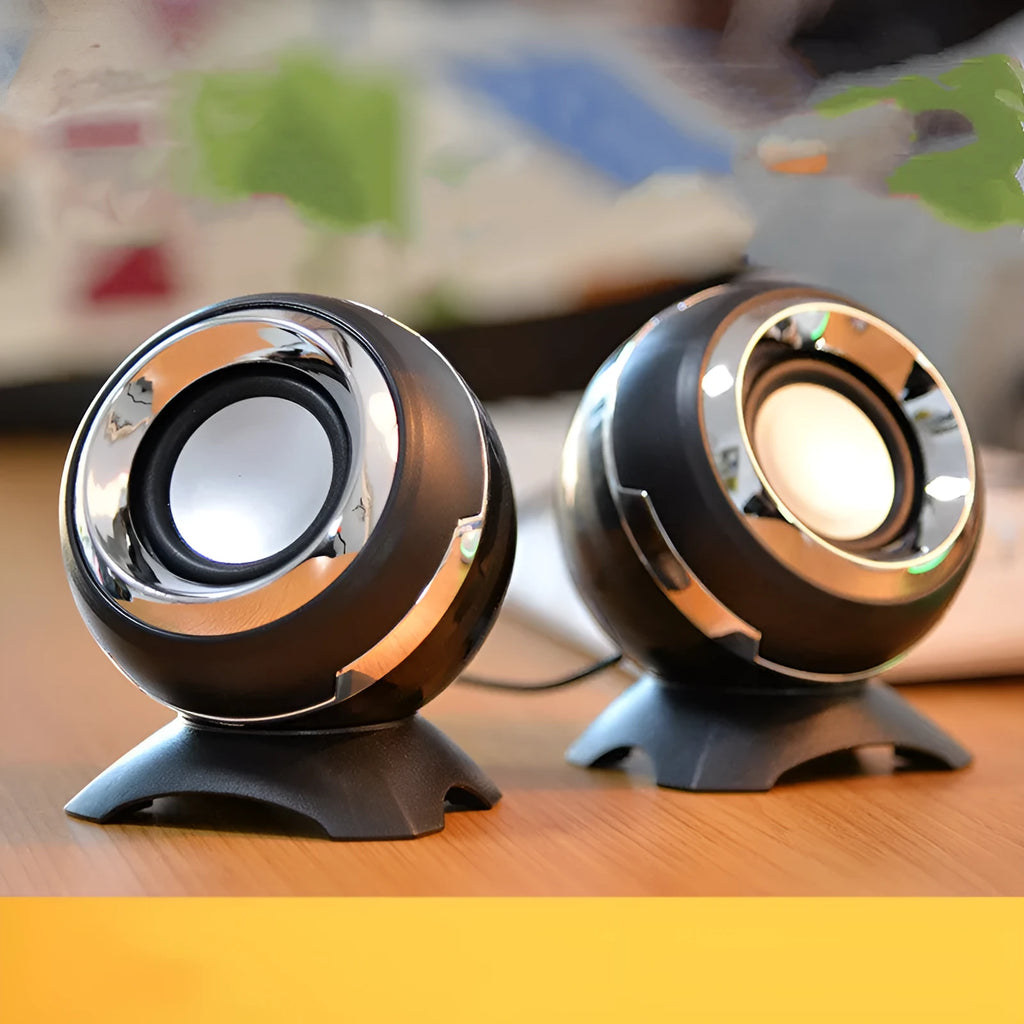 Compact black and gold desktop computer speakers with USB cable