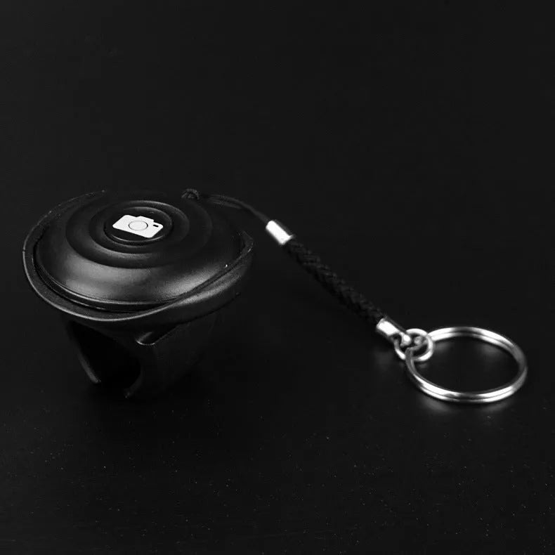 Black Snap Bluetooth remote control for camera shutter with 10-metre wireless range.
