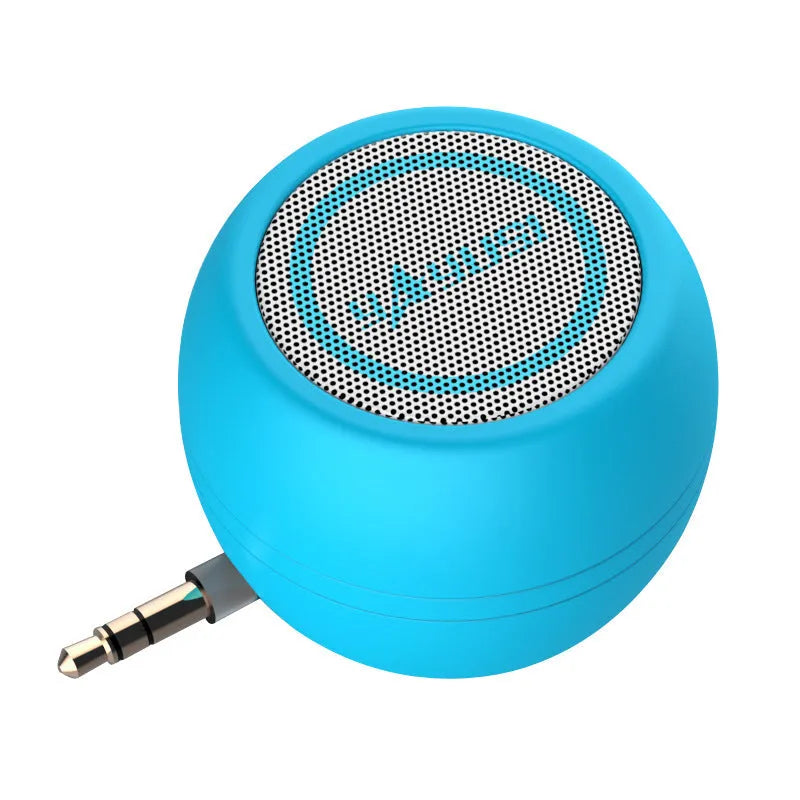 A5 portable mini speaker in red with 3.5mm audio plug and ABS plastic casing on a table