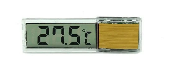 Gold digital thermometer mounted on aquarium glass showing temperature reading