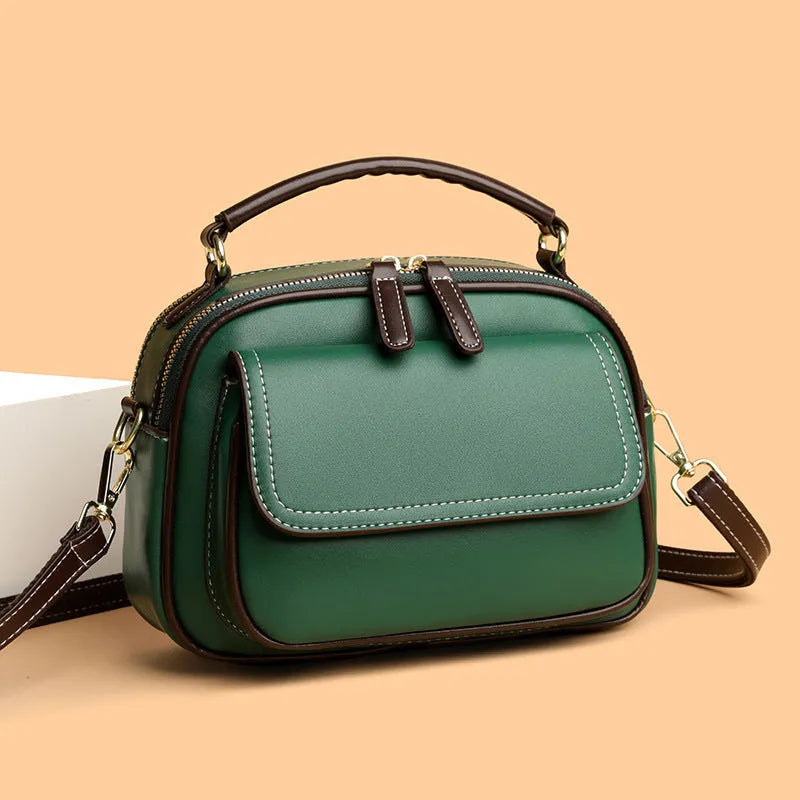 Black women's cross-body PU shoulder bag with adjustable straps showing its square shape and size.