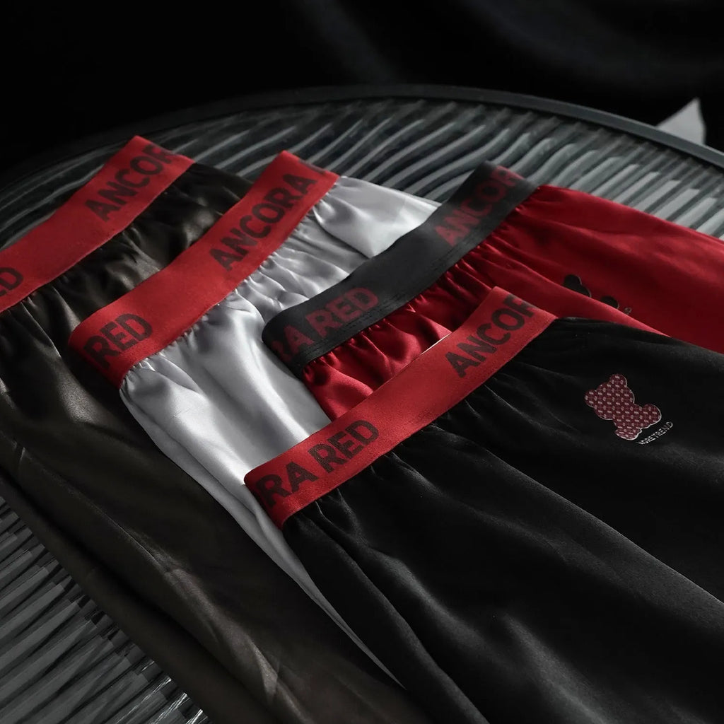 Solid colour men's polyester boxer briefs on a mid waist, shown in multiple colour options.