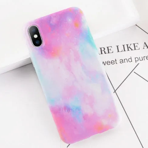 Colourful stone pattern soft back cover case for iPhone on a table.