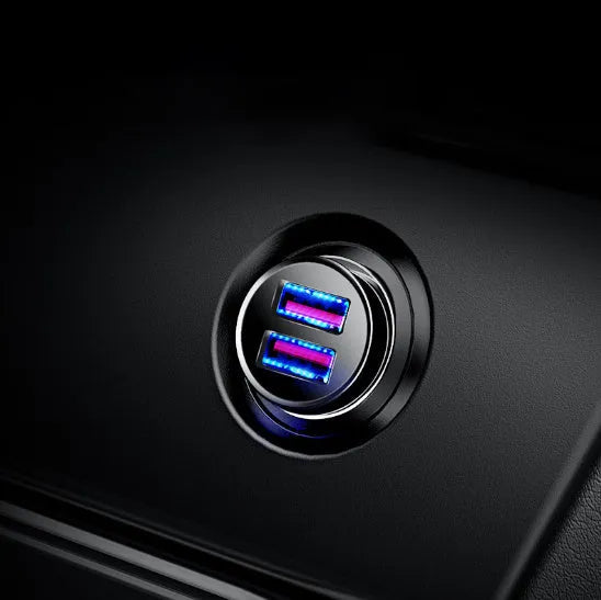 Black USB car charger with 4.8A fast charging plugged into a vehicle power socket.