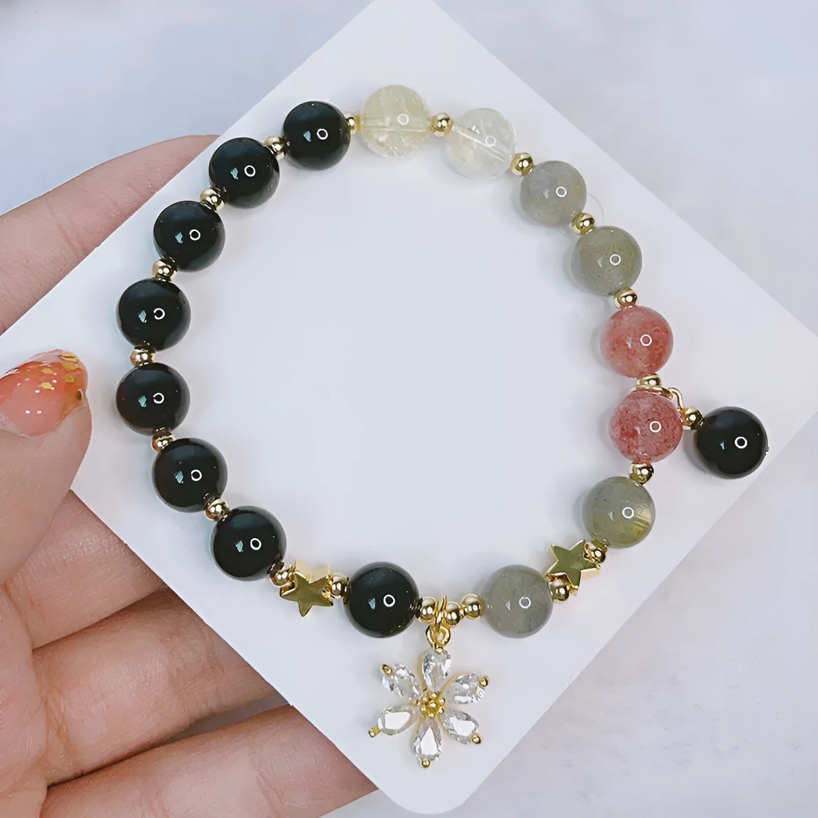 Women's silverstone charm bracelet with electroplated finish showing floral, heart, and star design options