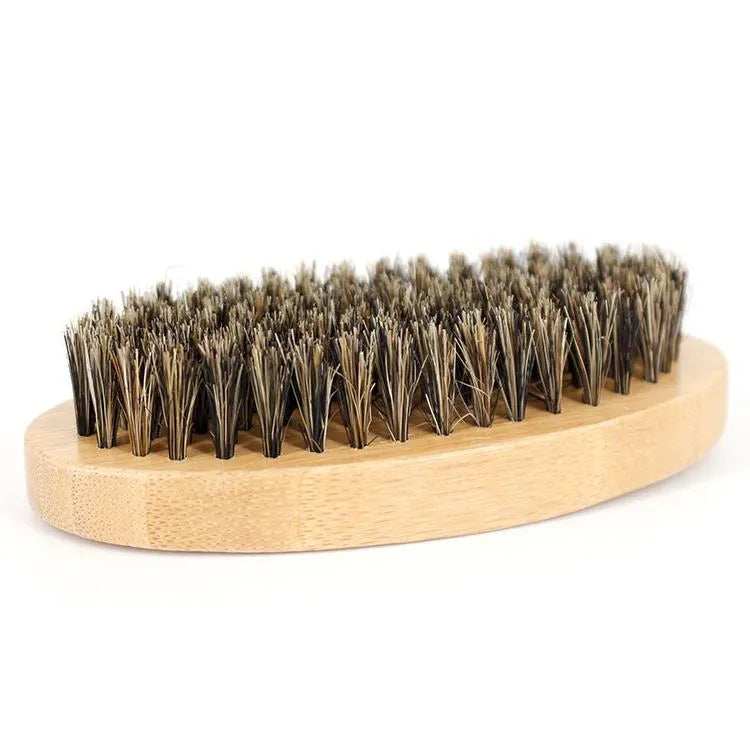six-piece beard care kit with beard cream, beard oil, peach wood comb, bristle brush, stainless steel scissors, and linen bag on a wooden surface
