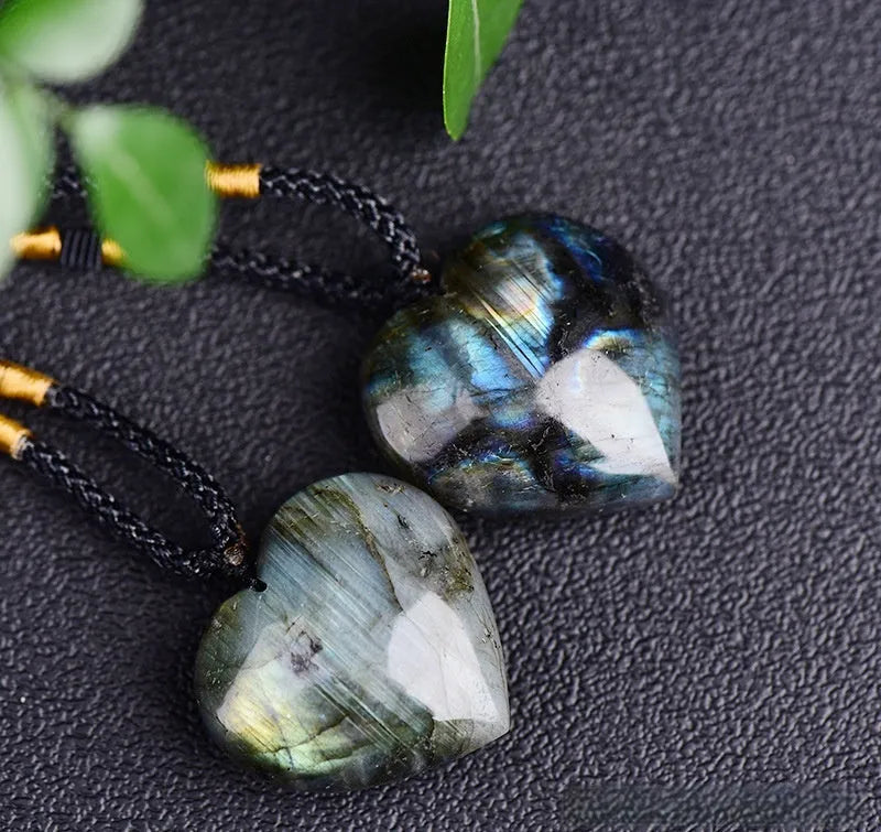 Light blue labradorite moonstone heart pendant necklace on a chain, geometric crystal design.