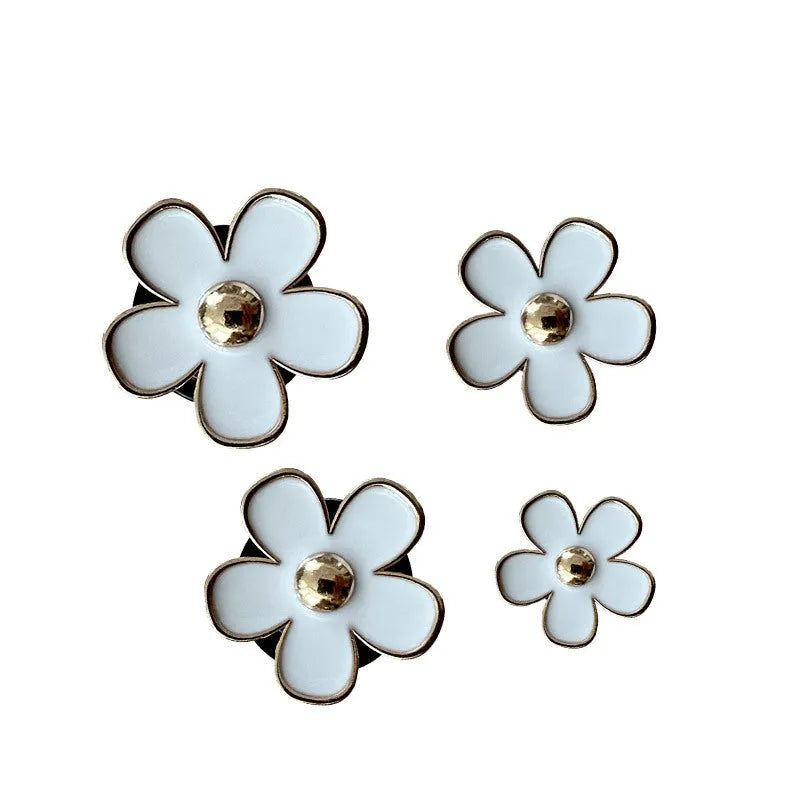 Set of four metal flower-shaped car vent aromatherapy clips in assorted colours