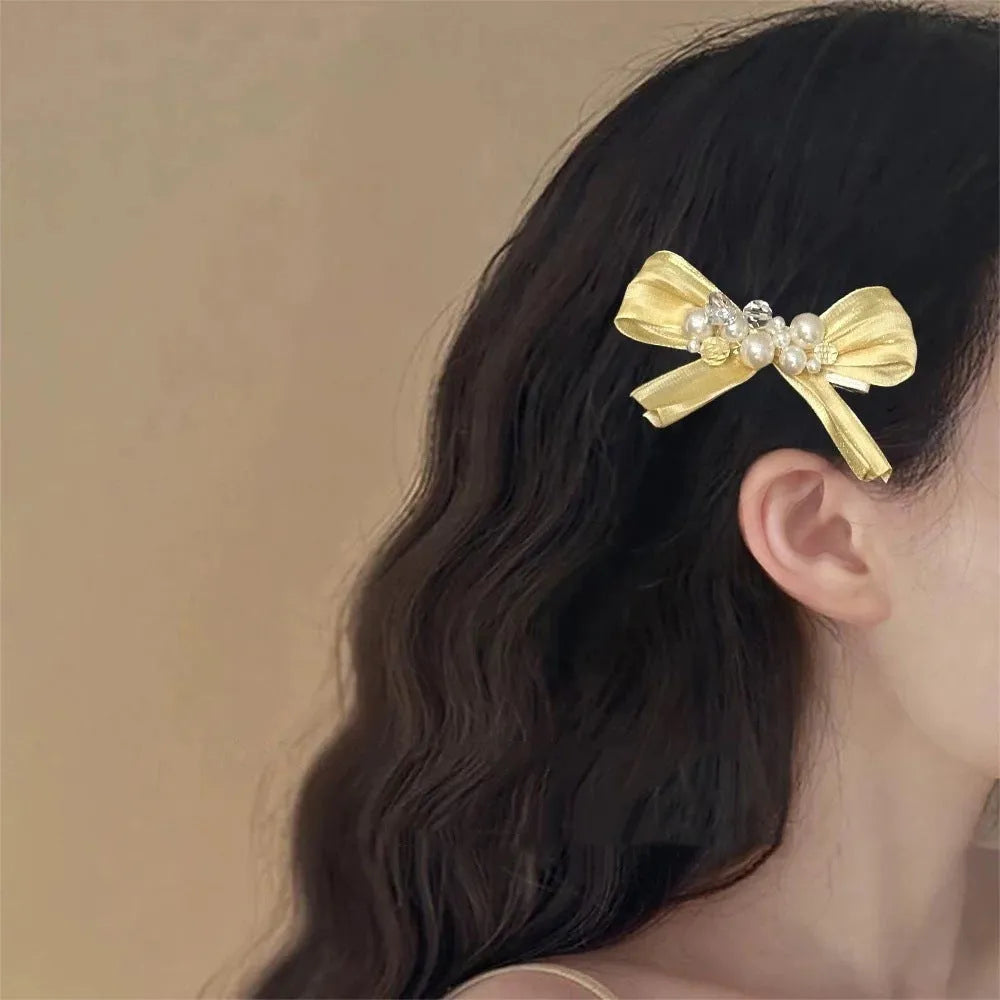 Yellow cloth bow hair clip with rhinestone and pearl decoration on duckbill hair grip