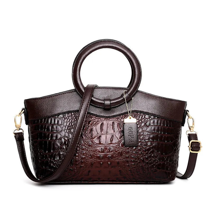 Ladies fashion handbag in multiple colours showing zipper compartments and shoulder strap