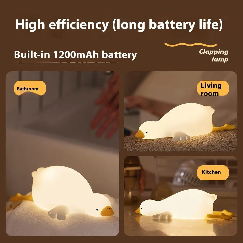 Big White Geese night light with warm white glow and silicone exterior on bedside table