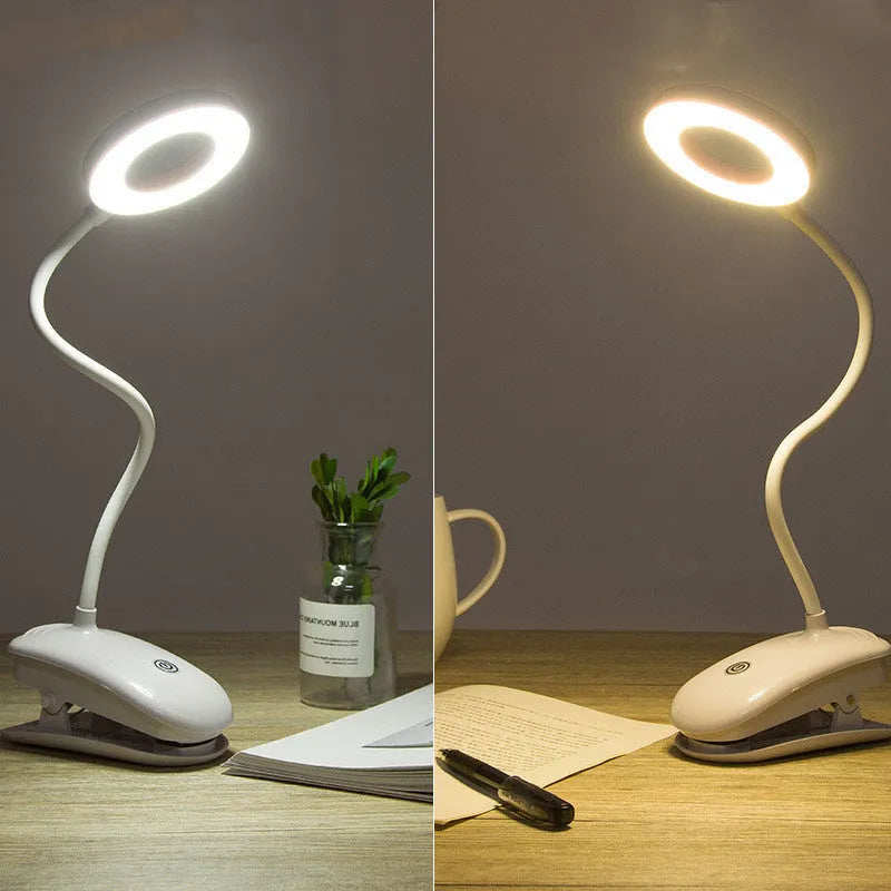 Modern clip-on rechargeable desk lamp with a white plastic shade and touch controls on its base.