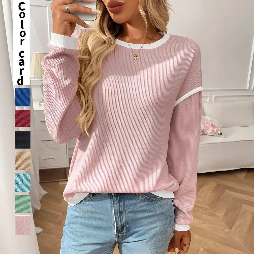 Women's loose-fit round neck long sleeve polyester pullover top on a hanger.