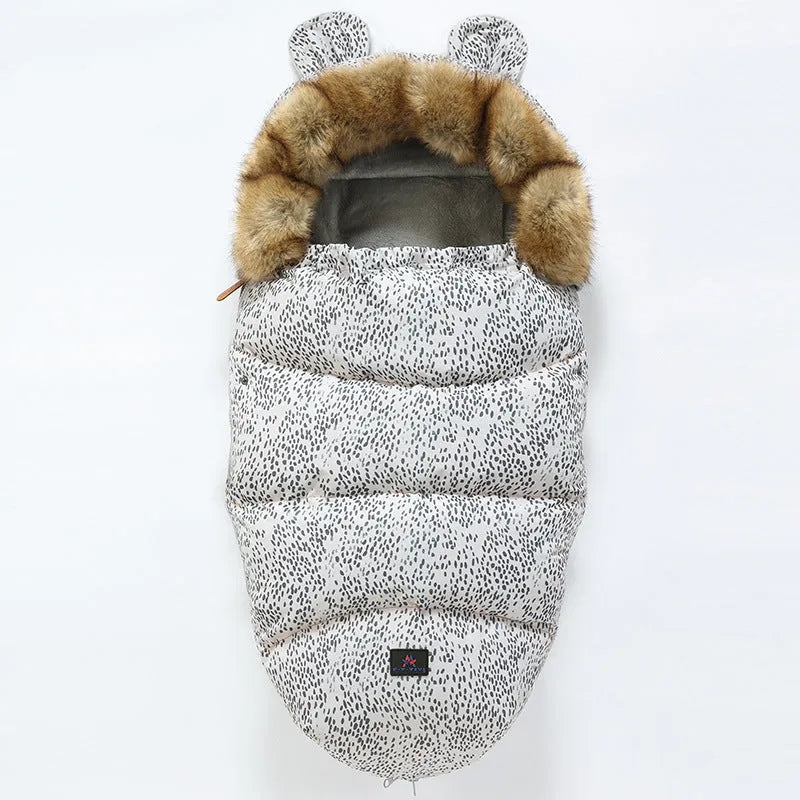 Convertible baby sleeping bag cocoon in a pram, showing cotton blend fabric and flannel lining.