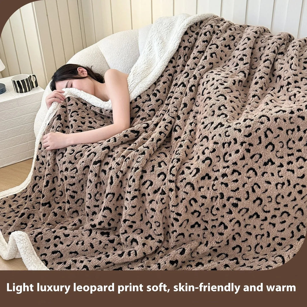 Double-layer taffeta blanket with woven leopard print pattern draped over sofa