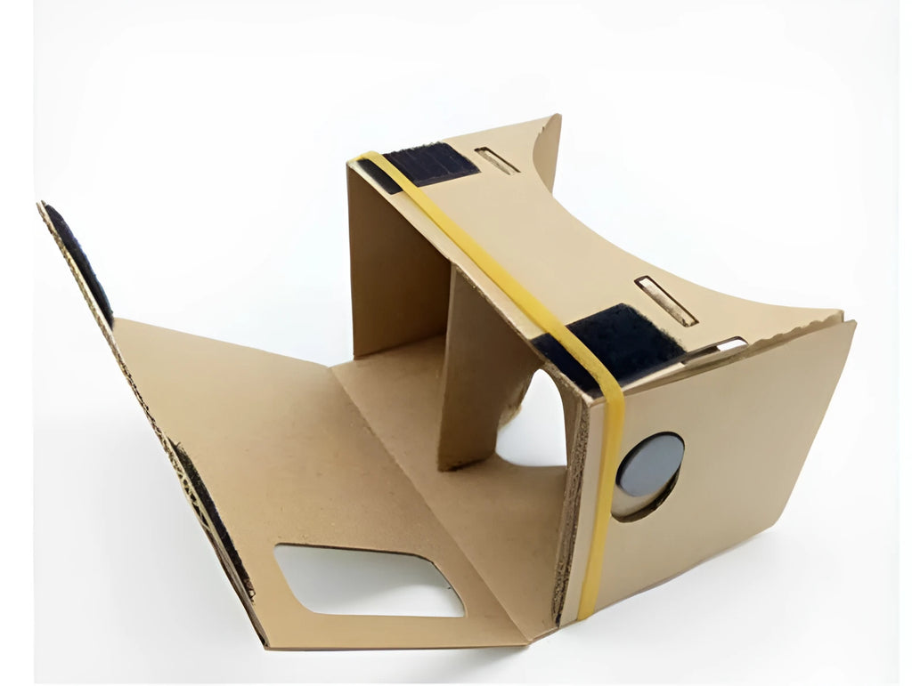 Pink and white foldable VR cardboard glasses for mobile phones, showing 3D lenses and rubber band.