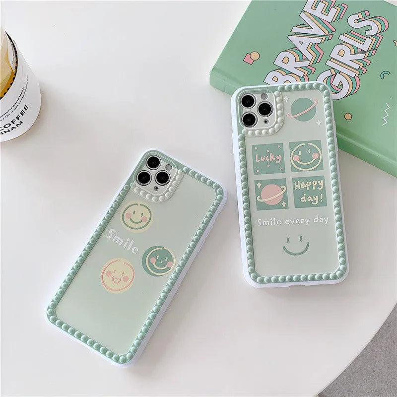 Green TPU iPhone back cover case with geometric smiley face and polka dot frame pattern.
