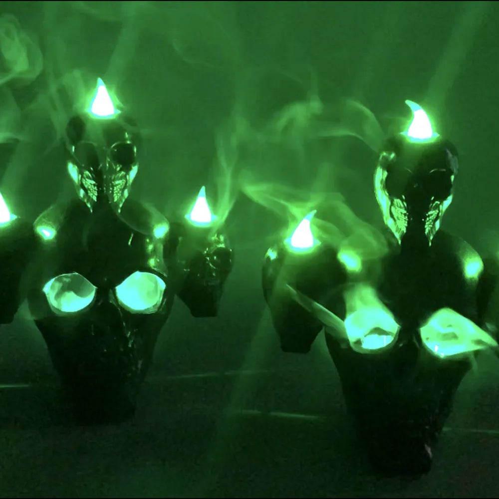 Halloween skull ornament with LED light, gold and silver, plastic, 14x12x9cm, on dark background