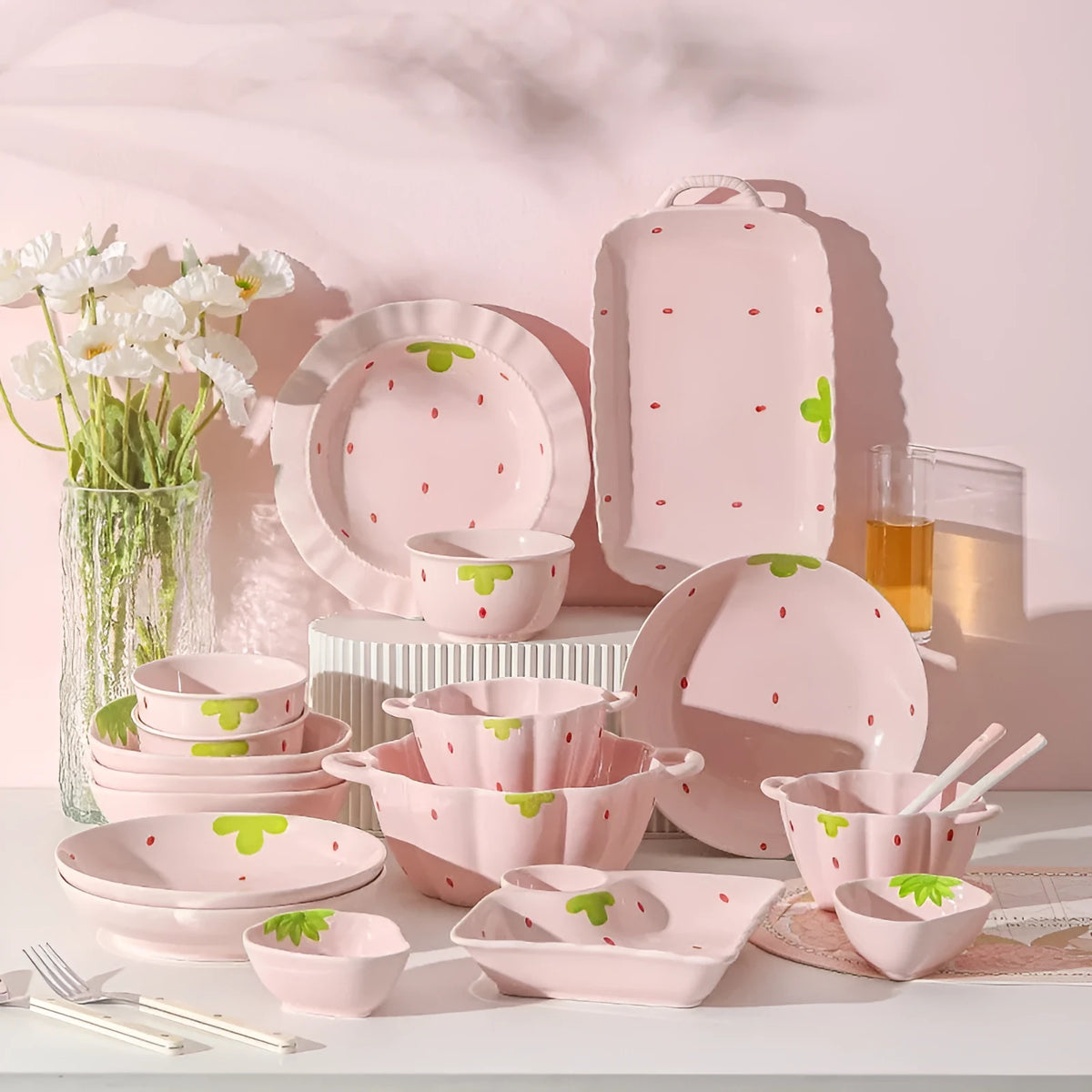 Cute porcelain dinnerware set with strawberry design, instant noodle bowl, twist spoon, and flower-shaped plates on table.