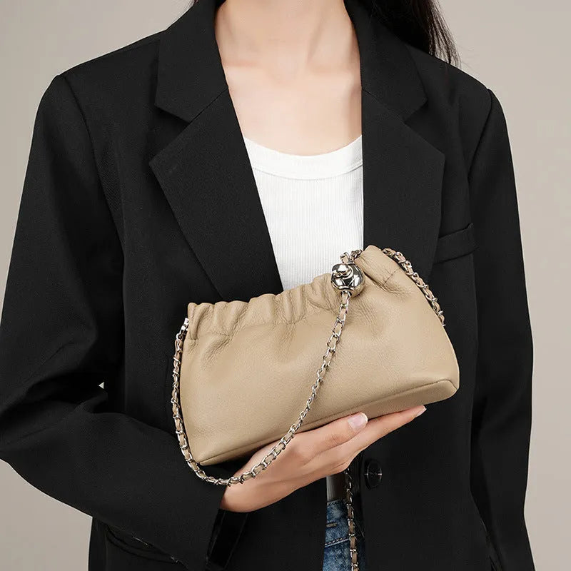Women's soft cowhide leather crossbody bag in dumpling shape with a single strap.