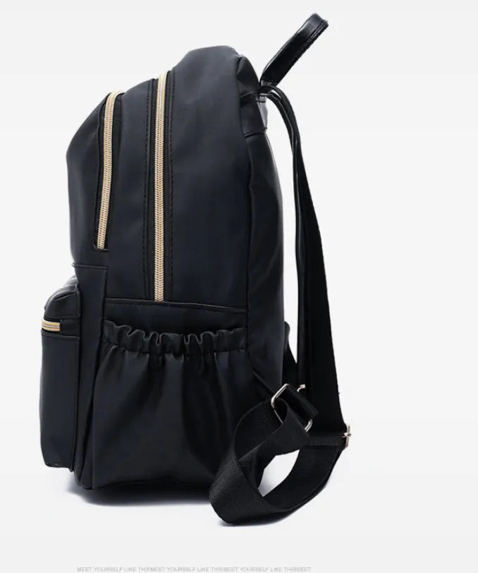 Black waterproof Oxford cloth backpack for women, 34x26x13cm, with two straps and front pocket on plain background