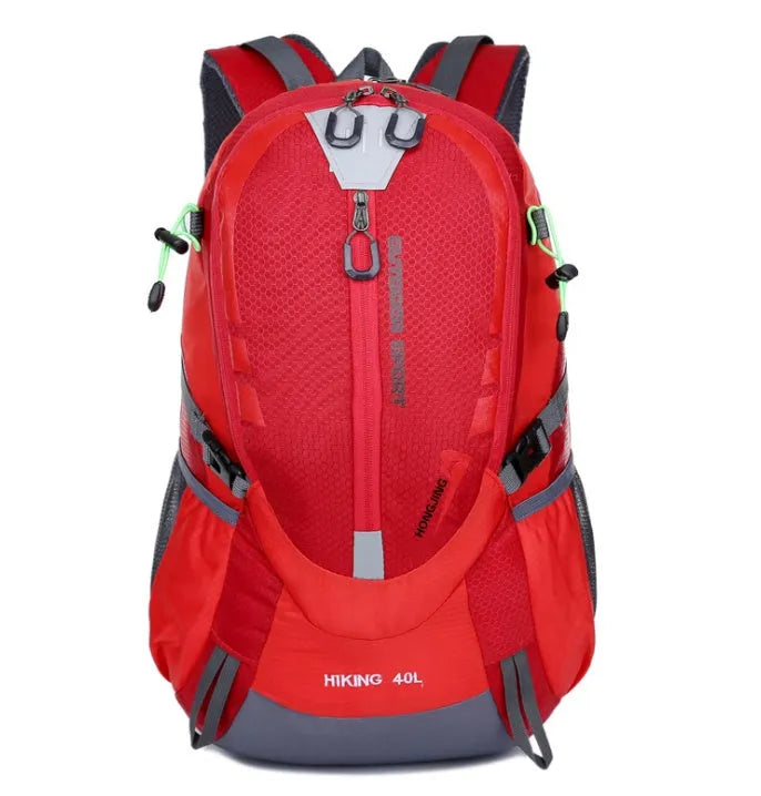 Nylon mountaineering backpack with zipper closure, square vertical section shape, soft handle, and double shoulder straps in outdoor setting