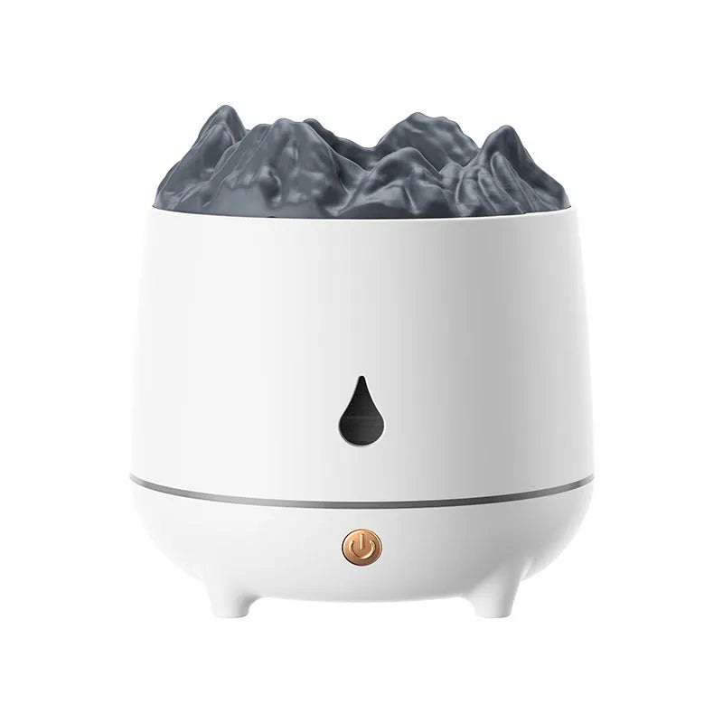 White volcano-shaped ultrasonic humidifier with USB cable on a wooden desk.