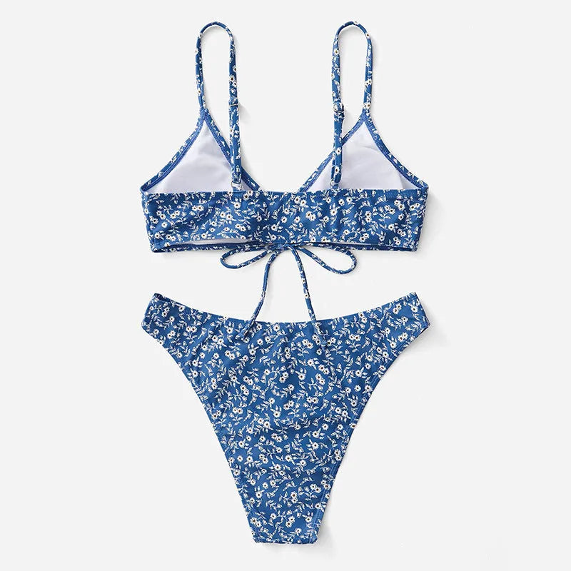 Blue three-piece swimsuit set with top and shorts on white background