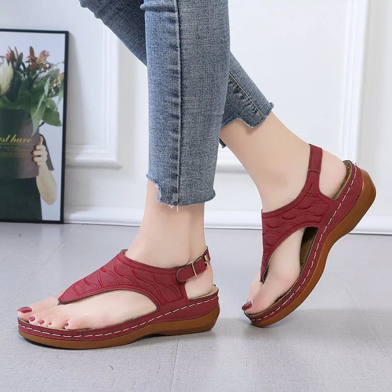 Women's solid colour wedge heel flip flop sandals with an adjustable buckle strap.