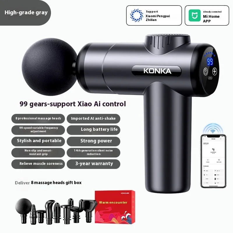 Konka professional electric mini massage gun in grey with multiple massage heads on a table