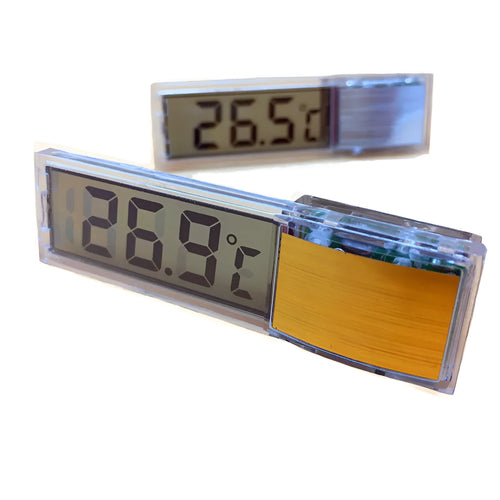 Gold digital thermometer mounted on aquarium glass showing temperature reading