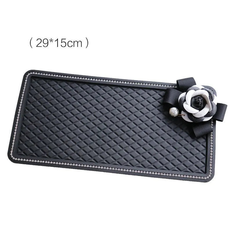 Black silicone car anti-slip mat on dashboard holding a mobile phone L size