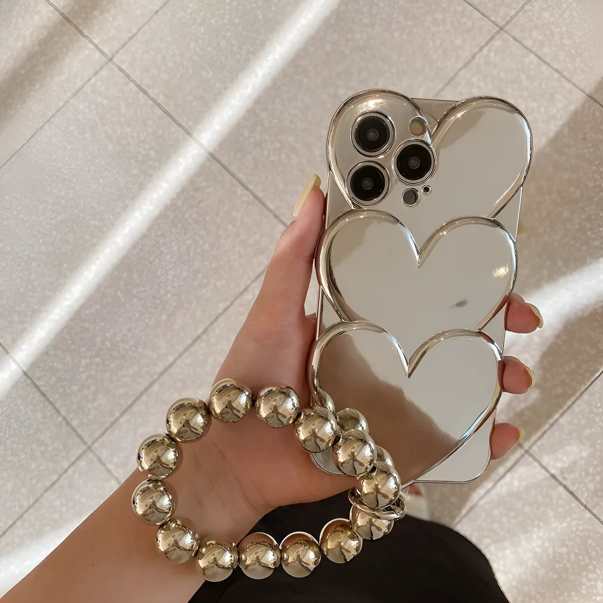 Electroplated love design TPU soft shell mobile phone case for iPhone, shown with optional matching bracelet.