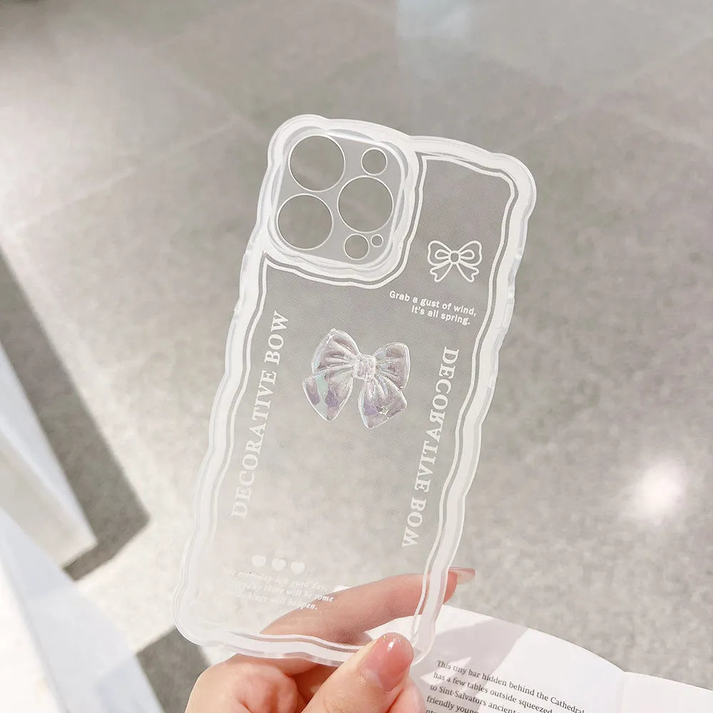 Clear transparent iPhone case with a raised ice-blue bow decoration on the back