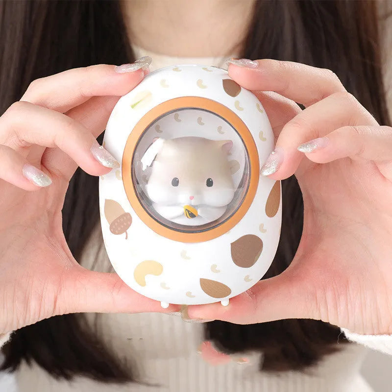 White Hamster space capsule-shaped hand warmer and power bank with USB port