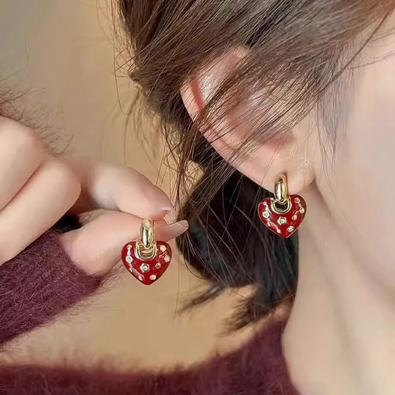 Pair of red heart-shaped ear studs in zinc alloy with electroplated finish
