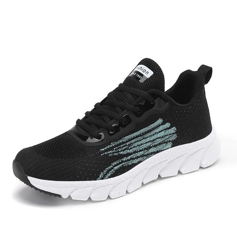 Women's low-top platform running sneakers in black and white colours with round toe and cross strap design