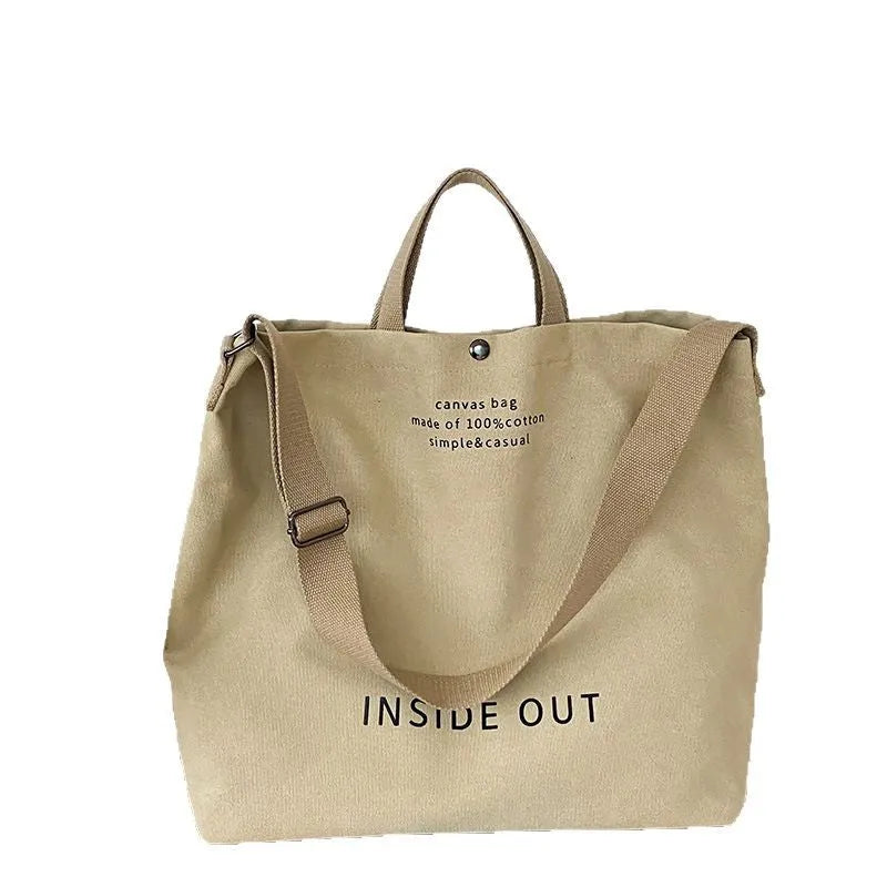 Washed canvas crossbody handbag in Army Green with horizontal square shape, outer sandwich pocket, and single strap on white background