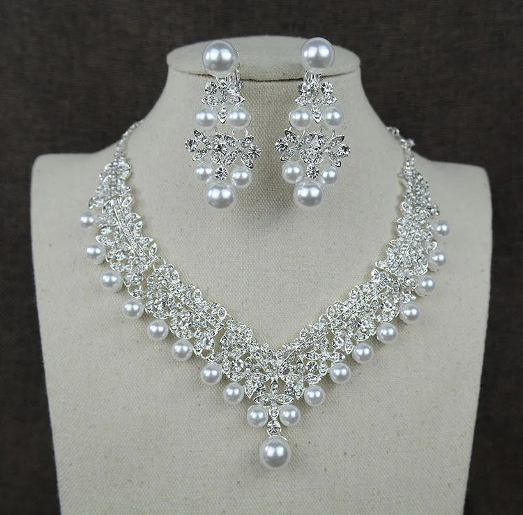White pearl and crystal bridal set with necklace, earrings, and hair accessory on display