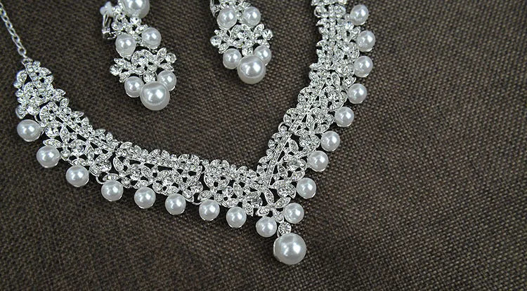 White pearl and crystal bridal set with necklace, earrings, and hair accessory on display